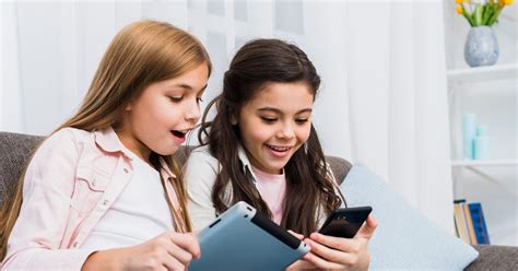 Dieťa sediace pri okne s telefónom